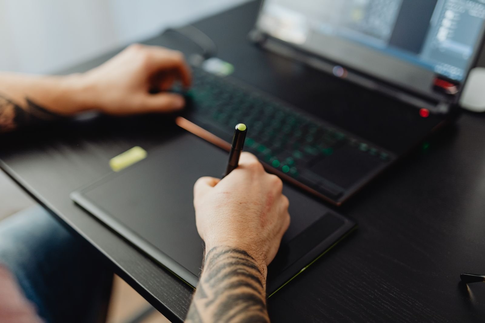 Designer working on a graphic tablet in a dim studio